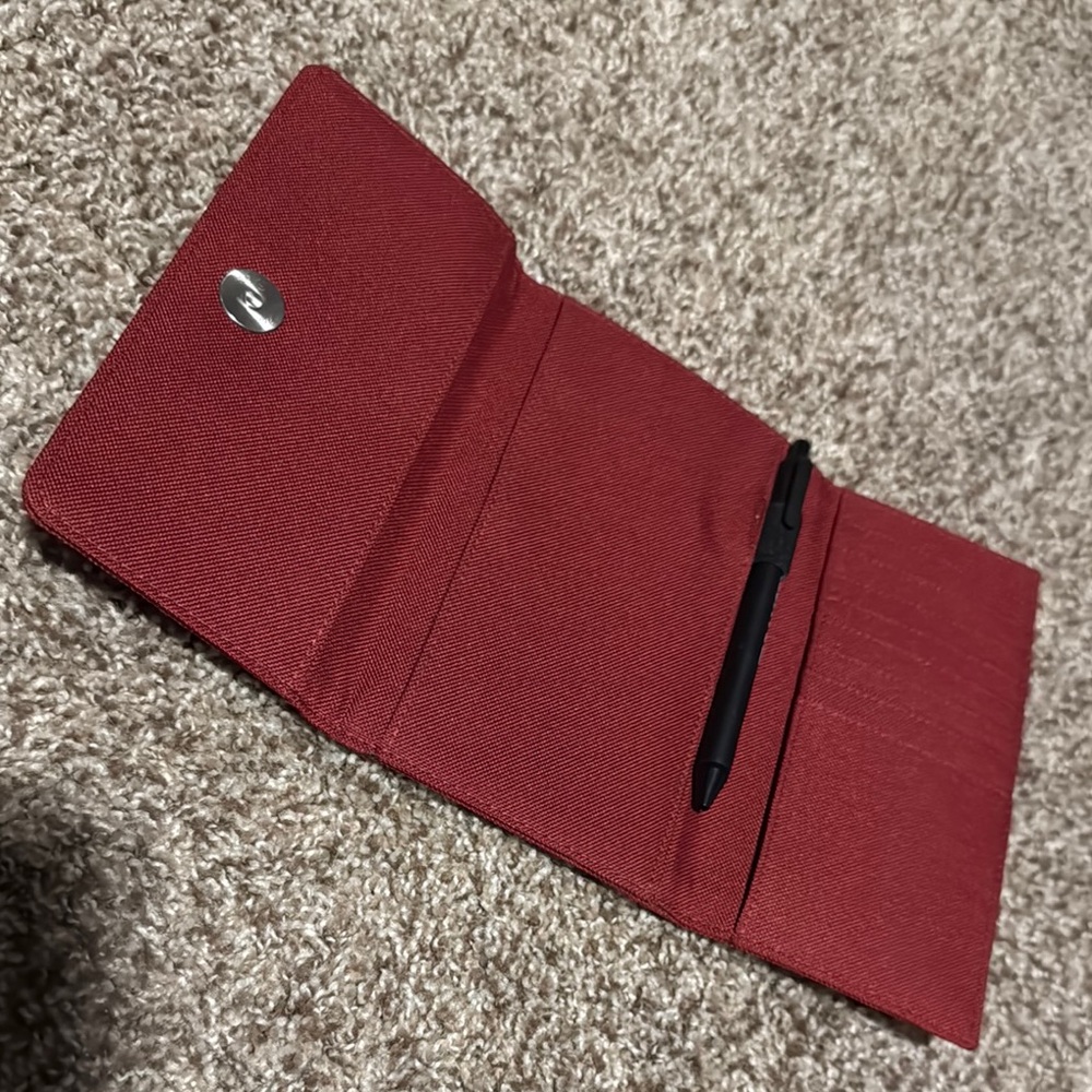 Like new burgundy nylon tri-fold planner cover or travel wallet w/pen